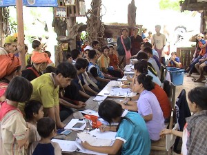 Myndighetspersoner tar emot registrering av papperslösa i en by